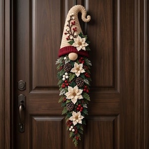 May include: A vertical gnome-shaped wall hanging featuring a beige crocheted hat with a curled tip, a dark red brim, and a round nose. The beard is composed of green pine needles, brown pinecones, white berries, red berries, and cream flowers.
