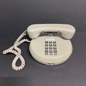 Vintage beige tan coloured touch tone, push button northern telecom round phone 1986 made in Taiwan