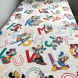 Vintage pacific Disney full size flat bedsheet with Pluto, Minnie, mickey, Donald Duck and letters in white, red and multiple colours