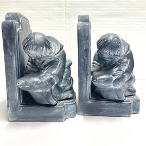 Vintage native inuit pair of bookends pair ceramic man holding a fish figurines set of 2 grey cast bookends