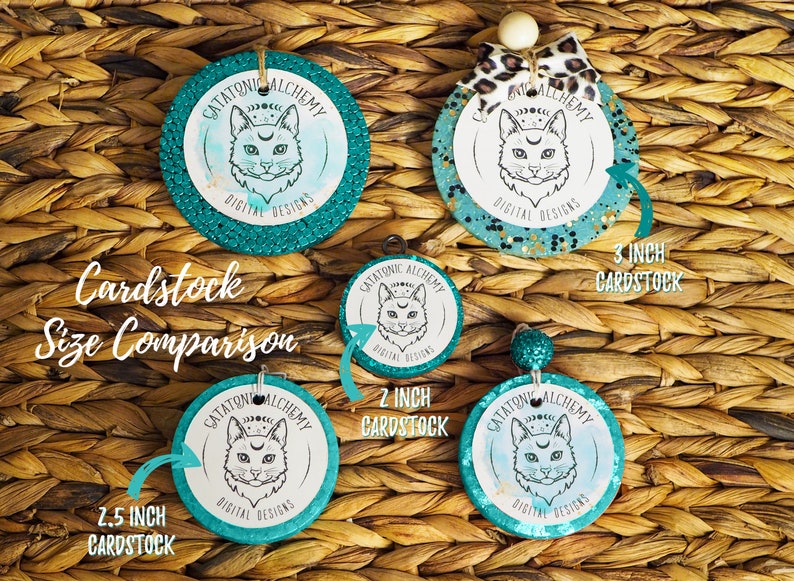 May include: A size comparison of four round teal and gold glitter cardstock circles with a black and white cat illustration and the text "Catatonic Alchemy Digital Designs". The circles are 2.5 inches, 2 inches, and 3 inches in diameter.