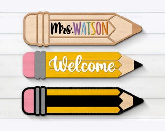 May include: Three wooden pencil-shaped signs. The top sign reads "Mrs. Watson" in colorful letters. The middle sign says "Welcome" in white. The bottom sign is a black and yellow pencil.