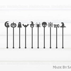 May include: Set of ten black Halloween-themed cocktail stirrers. The stirrers feature a variety of designs, including a crescent moon, a cat, a pumpkin, a ghost, a bat, a witch's hat, a spider, a skull, a spiderweb, and the word "BOO".