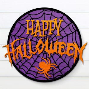 May include: A purple and black round sign with a spiderweb design and the words "Happy Halloween" in orange letters.