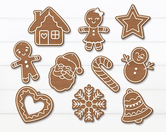 Puede incluir: Un conjunto de diez adornos de galletas de jengibre con forma de casa de jengibre, persona de jengibre, Papá Noel, bastón de caramelo, copo de nieve, campana, corazón, muñeco de nieve, estrella y niña de jengibre. Los adornos son todos marrones y blancos.