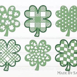 Puede incluir: Seis diseños de trébol verde con diferentes patrones. Los patrones incluyen lunares, cuadros, corazones y tréboles. Los tréboles están delineados en negro.