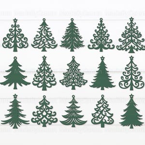 May include: A collection of dark green Christmas tree cutouts in various designs, including solid and ornate styles. Each tree has a star at the top and a small hole for hanging. The trees are arranged on a white, wood-grain background.
