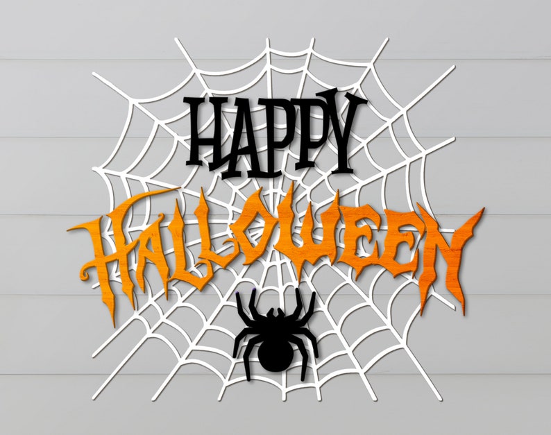 May include: A white spiderweb with the words "Happy Halloween" in black and orange letters. A black spider is in the center of the web.