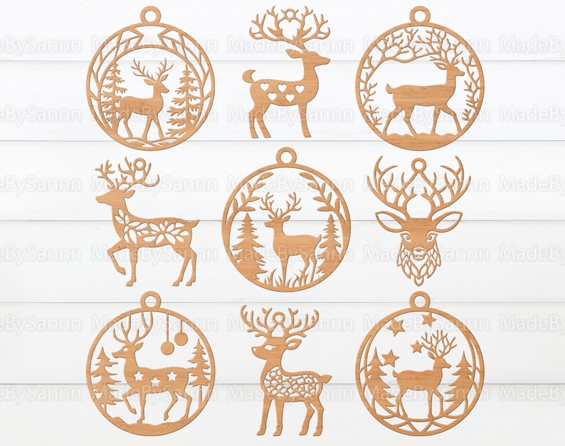 May include: Nine wooden ornaments featuring a deer design. Each ornament is circular and has a hole at the top for hanging. The deer are depicted in various poses, including standing, running, and with antlers. Some ornaments have a floral design, while others have a star design.