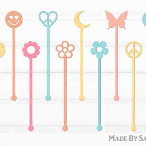 May include: A collection of colorful drink stirrers in various shapes, including a smiley face, peace sign, flower, butterfly, and crescent moon. The stirrers are in pastel shades of yellow, pink, and blue. The text "MADE BY SANNN" is at the bottom.