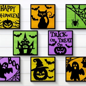 May include: Eight Halloween-themed wooden signs with black cutouts. The signs feature a variety of spooky designs, including a pumpkin, a ghost, a spider, a witch, a haunted house, and bats. The signs are painted in various colours, including green, yellow, purple, and orange.