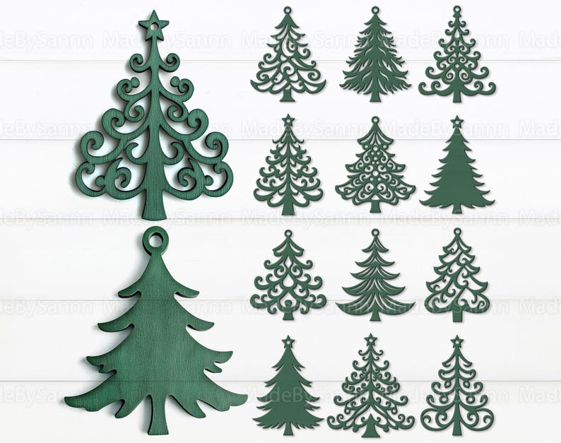 May include: A collection of green wooden Christmas tree ornaments in various styles. Some have intricate cut-out designs, while others are solid. Several have star toppers, and one has a loop for hanging. The ornaments are displayed on a white background.