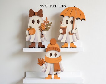 May include: Three ghost-shaped wooden cutouts featuring autumn themes. One ghost wears a brown bow and holds a pumpkin and leaves. Another holds a coffee cup and an orange umbrella. The third wears an orange beanie and scarf while holding a leaf.