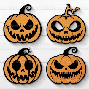 May include: Four orange jack-o'-lantern pumpkins with black eyes, noses, and mouths. The pumpkins are on a white wood background.