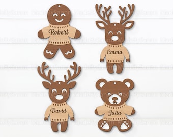May include: Four wooden Christmas ornaments with names on them. The ornaments are a gingerbread person, a reindeer, a bear, and another reindeer. The ornaments are all brown and have a light brown sweater with a name on it. The names are Robert, Emma, David, and Julia.