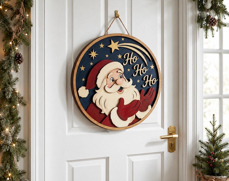 May include: A circular wooden wall sign featuring a layered design of Santa Claus in a red suit and hat against a dark blue background. The sign includes gold-colored stars, a shooting star, and the text "Ho Ho Ho" in a script font, suspended by a rope.