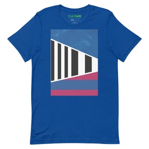 May include: A royal blue t-shirt with a graphic design featuring a geometric pattern in black, white, blue, and pink.