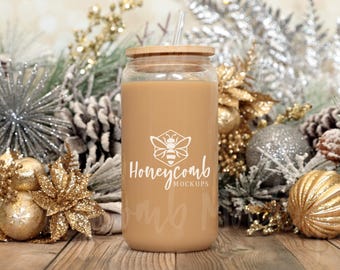 May include: A clear glass tumbler filled with a light brown beverage, featuring a bamboo lid and a clear straw. The front of the glass displays a white graphic of a bee inside a hexagon above the text Honeycomb MOCKUPS.
