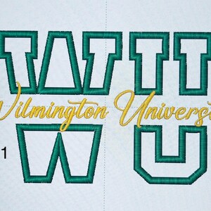 May include: Embroidered design featuring the words "Wilmington University" in gold script and the letters "WATTU" in green block letters. The design is on a white background, showcasing a collegiate theme.