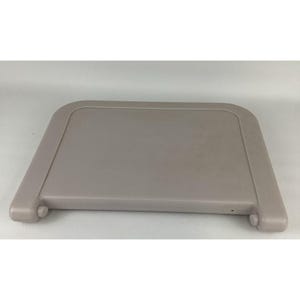 May include: A light gray, rectangular tray with rounded corners and a raised edge. The tray has two small, rounded protrusions on the bottom edge. The surface is smooth and appears to be made of plastic.