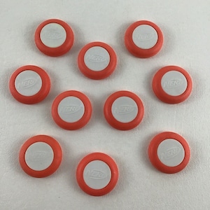 May include: Ten orange and white Nerf darts with the Nerf logo on the white center.