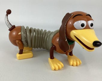 Perro Slinky de Toy Story de Disney Pixar, 30 cm + Figura de acción con luz y elástico