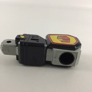 May include: Black and gray plastic toy robot arm with a yellow and red logo that says "Power Rangers".