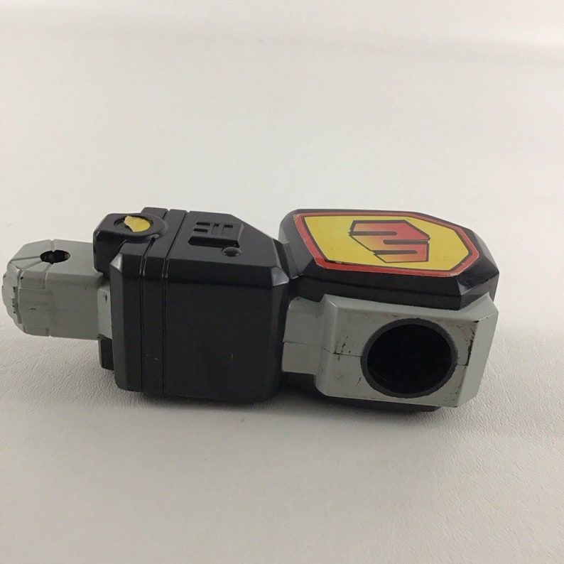 May include: Black and gray plastic toy robot arm with a yellow and red logo that says "Power Rangers".