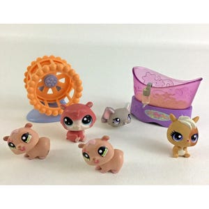 May include: A collection of five small plastic animal figurines with large eyes, including three light brown hamsters, one grey mouse, and one tan squirrel. Accessories include an orange exercise wheel on a blue base and a purple bathtub.