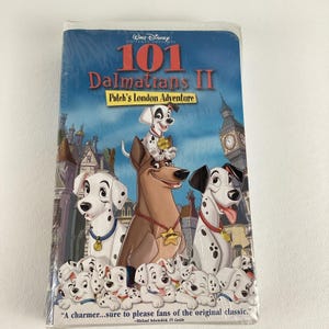May include: Sealed VHS tape of Disney's "101 Dalmatians II: Patch's London Adventure." The cover features illustrations of Dalmatian dogs, a brown dog, and London landmarks. The text reads "A charmer...sure to please fans of the original classic."