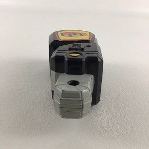 May include: Black and gray toy weapon with a yellow and red logo on the side. The weapon has a textured gray barrel and a black handle.