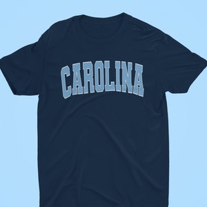 Peut inclure: Un t-shirt bleu marine avec le mot "CAROLINA" imprim&eacute; en bleu clair sur le devant.