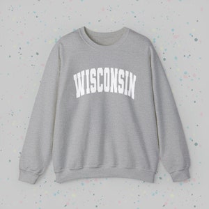 May include: A gray sweatshirt with the word "WISCONSIN" printed in white on the front.