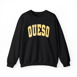 May include: Black sweatshirt with a gold "QUESO" graphic printed on the front.