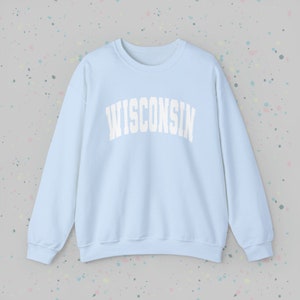 May include: A light blue sweatshirt with the word "WISCONSIN" printed in white on the front.