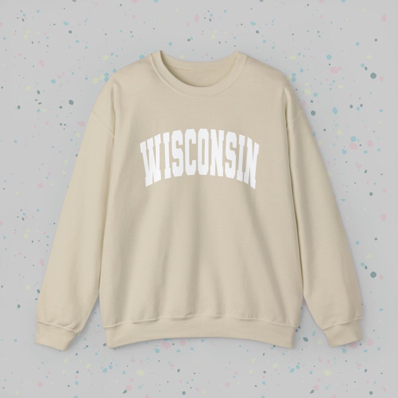 May include: A beige sweatshirt with the word "WISCONSIN" printed in white on the front.
