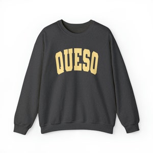 May include: A dark gray sweatshirt with a yellow "QUESO" graphic printed on the front.