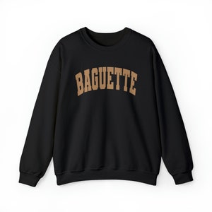 May include: Black sweatshirt with a brown arch design that reads "BAGUETTE".