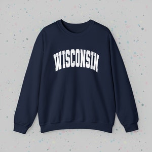 May include: A navy blue sweatshirt with the word "WISCONSIN" printed in white in an arched font.
