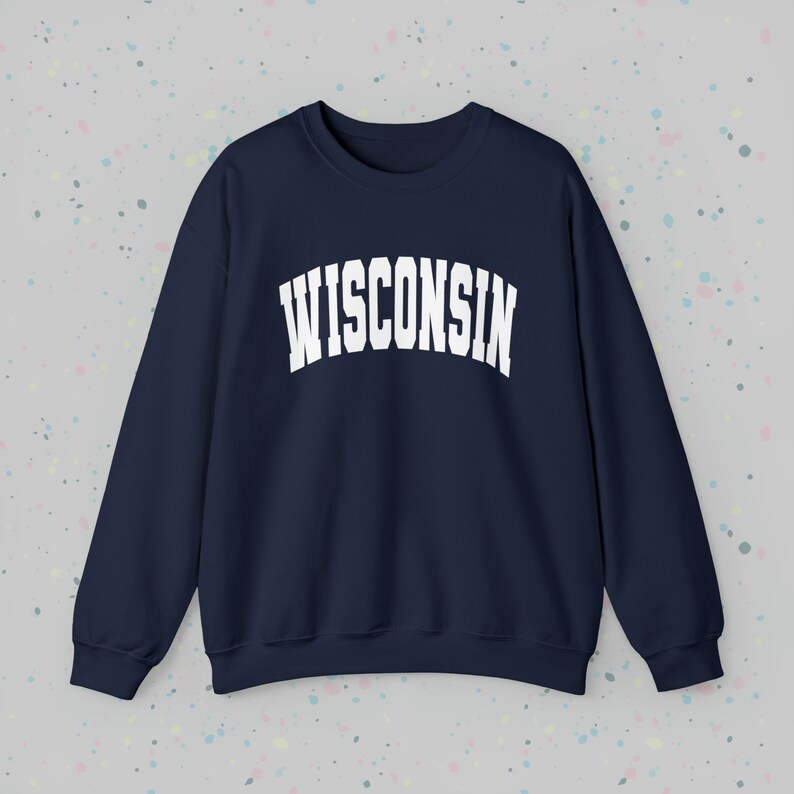 May include: A navy blue sweatshirt with the word "WISCONSIN" printed in white in an arched font.
