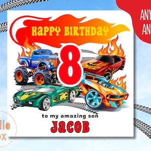 May include: A birthday card with a red, orange and yellow flame design. The card features a blue monster truck, a red sports car and an orange sports car. The number 8 is in the centre of the card in red. The text "Happy Birthday" is in yellow and the text "to my amazing son Jacob" is in red.