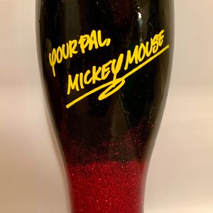 May include: Black and red glitter tumbler with the text "Your Pal, Mickey Mouse" in yellow lettering.