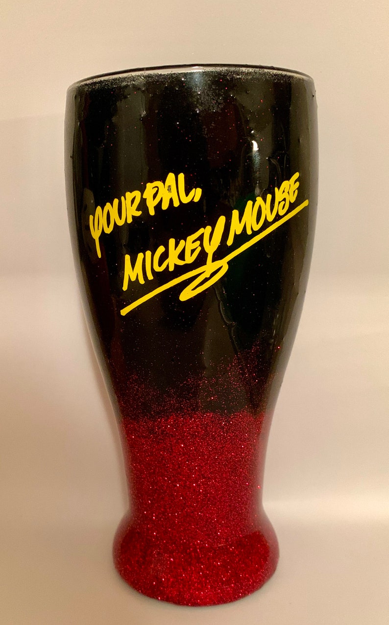May include: Black and red glitter tumbler with the text "Your Pal, Mickey Mouse" in yellow lettering.