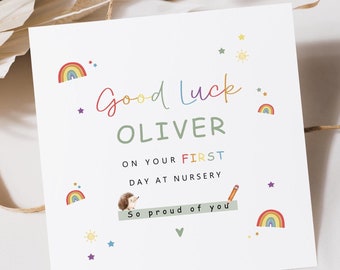 May include: A colorful card with a rainbow, stars, and a sun. The card says "Good Luck Oliver on your first day at nursery. So proud of you."
