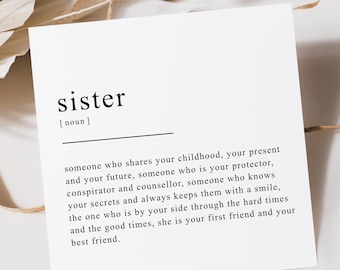 Könnte beinhalten: Eine weiße Karte mit schwarzem Text, der das Wort "Schwester" als jemanden definiert, der deine Kindheit, Gegenwart und Zukunft teilt. Die Karte ist eine Definition des Wortes Schwester.
