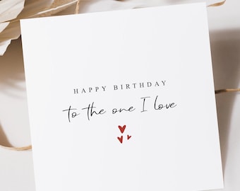 May include: White card with the text "Happy Birthday to the one I love" in black script. Three small red hearts are below the text.