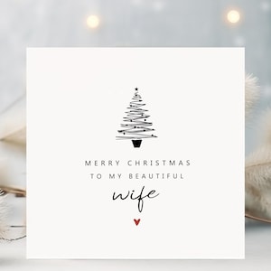 May include: A square Christmas card with a minimalist design. The card features a black line drawing of a Christmas tree, the text "MERRY CHRISTMAS TO MY BEAUTIFUL wife", and a small red heart.