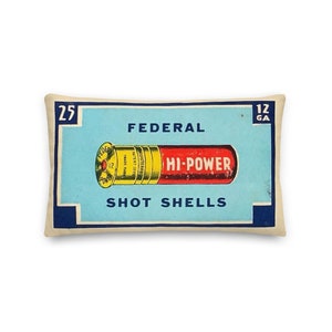 May include: A vintage-style pillow featuring a blue and white box with the text "FEDERAL HI-POWER SHOT SHELLS" and a red and yellow shotgun shell illustration. The box also has the numbers "25" and "12 GA" printed on it.