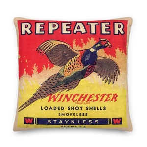 May include: Vintage Winchester Repeater loaded shot shells box with a pheasant in flight against a red and yellow background. The box reads "Winchester Trade Mark Loaded Shot Shells Smokeless StayNLess Made in U.S.A."