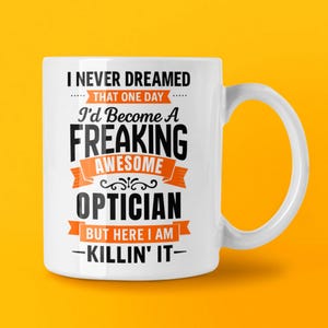 May include: A white ceramic mug with a black handle and the text "But First, Coffee" in a black, bold font. The mug is on a white surface.